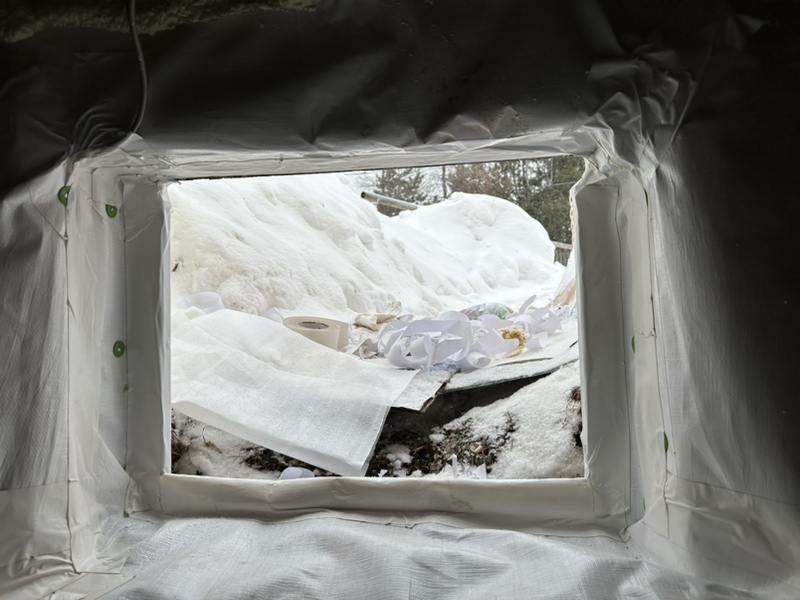 This image shows a newly encapsulated crawl space with snow on the ground outside.